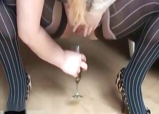 Thick blonde in stockings pissing into the glass