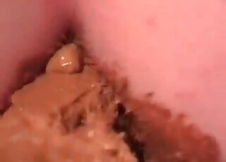 Dildo covered in feces is going in and out