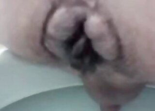 Poop coming out of a hairy ass in a close angle